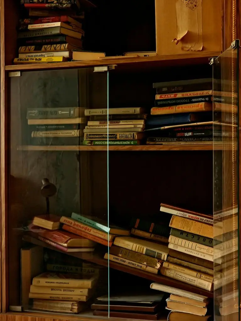 Libros antiguos apilados en una estantería de madera